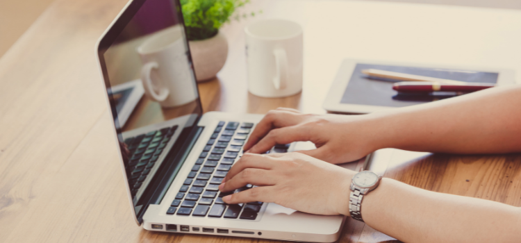 Lady typing on her laptop