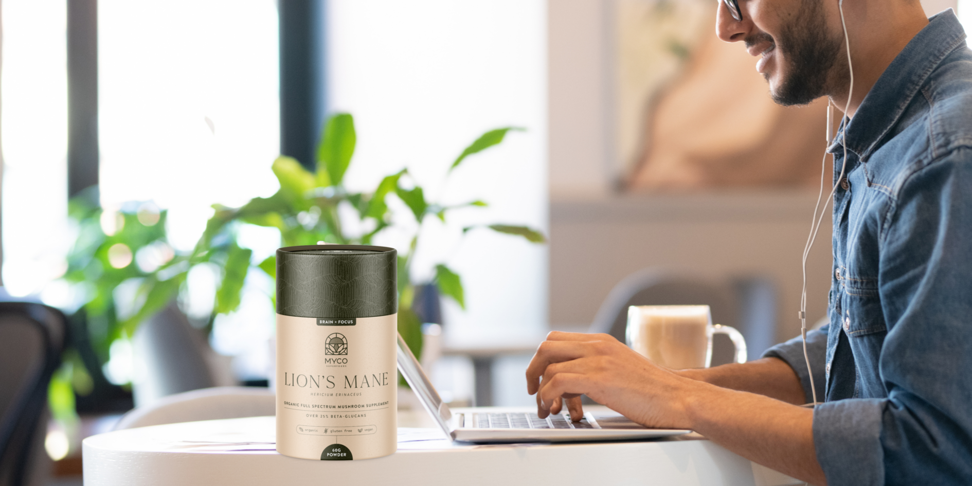 Lion's Mane supplement container on a desk with man working