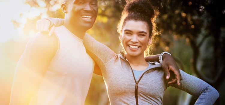 Male and female with arms around each other smiling