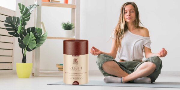 Reishi Mushroom Supplement with lady meditating in background